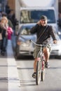 Man riding bicycle and talking on the phone