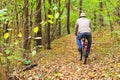 Man is riding a bike in autumn forest