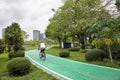 BANGKOK, THAILAND - APRIL 7, 2018: A man riding bike on the green lane in the park