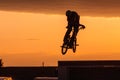 A man riding a bike jumping in the air doing tricks Royalty Free Stock Photo