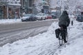 Man riding bike on Saint-Denis street during snow storm