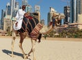 A man riding a camel on the beach Royalty Free Stock Photo