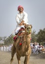 Man riding a camel in a countryside of Oman