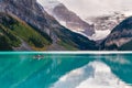 Man riding a Canoe on iconic turquoise Lake Louise in the Canadian Rockies