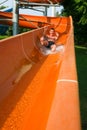 Man riding down a water slide Royalty Free Stock Photo