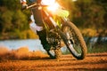 Man riding enduro motorcycle on dirt field