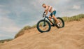 Man riding a fat bike through the beach dunes Royalty Free Stock Photo