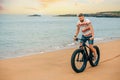 Man riding a fat bike on the beach Royalty Free Stock Photo