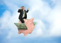 Man riding flying piggy bank on wings of money showing financial and business success Royalty Free Stock Photo