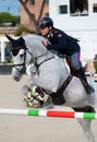 Man riding horse and jumping during equestrian competition close up detail