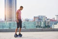Man riding hoverboard, city background. Royalty Free Stock Photo