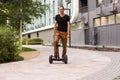Man riding hoverboard, city. Guy on blue gyroboard Royalty Free Stock Photo