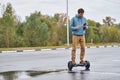 Man riding on the hoverboard and using smartphone outdoor Royalty Free Stock Photo