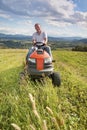 Man riding a lawn tractor Royalty Free Stock Photo