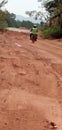 Man riding moter sycal on muddy road