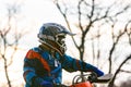 Man riding a motocross in a protective suit