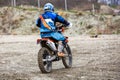 Man riding a motocross in a protective suit