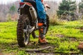 Man riding a motocross in a protective suit in the mud