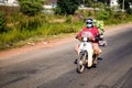 Man riding motorbike carrying heaps of fresh food