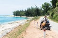 Man riding motorcycle along the sea on the road to Hai Van pass, Vietnam