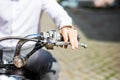 Man riding motorcycle, close up of hand on handlebar