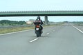 A man riding a motorcycle on the way in Poland.