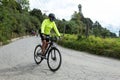 A man riding mountain bicycle over a asphalt road at bogota mountains