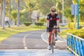Man riding mountain bike on bridge trail at sunrise at public pa Royalty Free Stock Photo