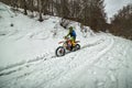 Man riding an off-road motorbike in extreme snowy weather condition