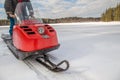 A man riding old red snowmobile on snow-covered lake Royalty Free Stock Photo