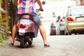 Man riding old retro scooter in a city street. Close up Royalty Free Stock Photo