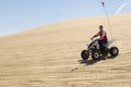 Man Riding Quad Bike In Desert Royalty Free Stock Photo