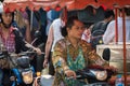 Man riding scooter, motorcycle in apron on Chatuchak market in Bangkok