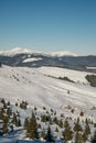 A man riding a snowboard down a snow covered mountain Royalty Free Stock Photo