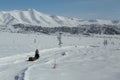 A man riding a snowmobile in the mountains.