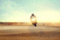 Man riding sport motorcycle on dirt road against urban building