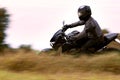 Man riding sport motorcycle leaning on curve road