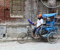 A man riding tricycle on street in Amritsar, India