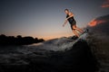 Man riding on the wakeboard on the pink sunset Royalty Free Stock Photo