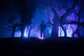 Man with riffle against zombie attack. Zombie apocalypse. Scary view of blurred zombies at cemetery and spooky cloudy sky with fog