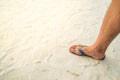 Man right foot with shoe walk on the beach sand Royalty Free Stock Photo