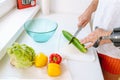 Man with injured hand making salad