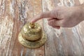 Man ringing in service bell on reception table, closeup Royalty Free Stock Photo