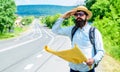 Man at road side with map. Expeditor backpacker map look orienteering direction. Orienteering topographic map. Expeditor Royalty Free Stock Photo