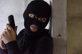 Man robber thief wear mask holding gun hiding