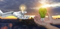 Man and robot holding earth map grass light bulb together on city. Green technology conceptual design, Ai robot hand holding Royalty Free Stock Photo