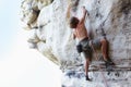 Man, rock climbing and mountain rope adventure or sports challenge, risk performance on stone crack. Male person Royalty Free Stock Photo