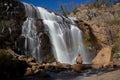 Man on a rock under a Rainbow in front of waterfall, Mackenzie Falls, Australia