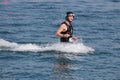 Man rocketing from the water on a flyboard