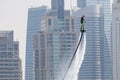 Man rocketing from the water on a flyboard